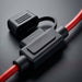 Black electrical connector with red wires on a dark background