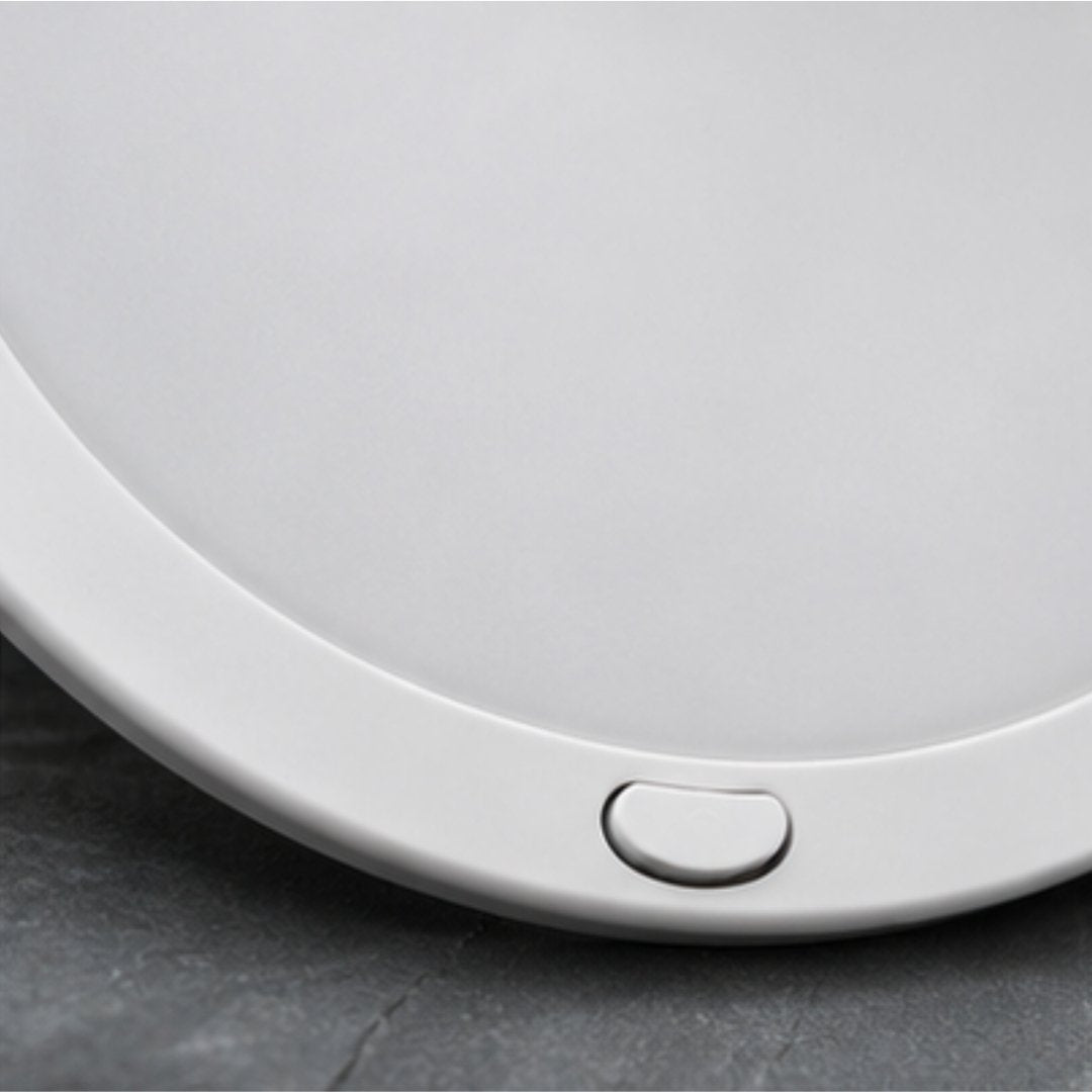 Round white light on a gray surface