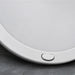 Round white light on a gray surface