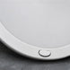 Round white light on a gray surface