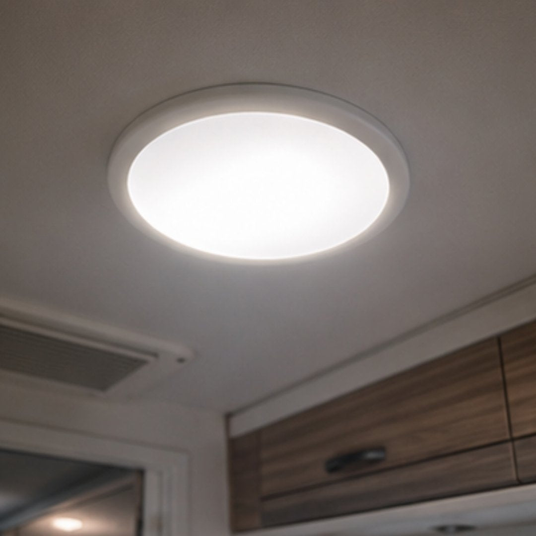 Ceiling light fixture on a white ceiling with wooden cabinets below
