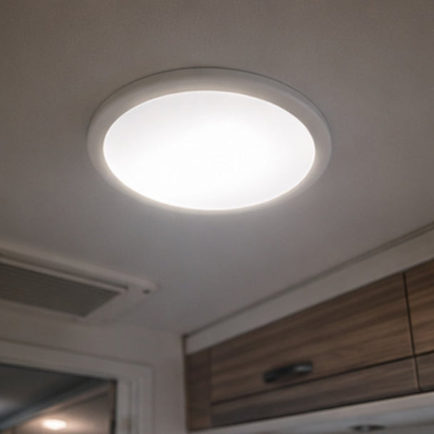 Ceiling light fixture on a white ceiling with wooden cabinets below