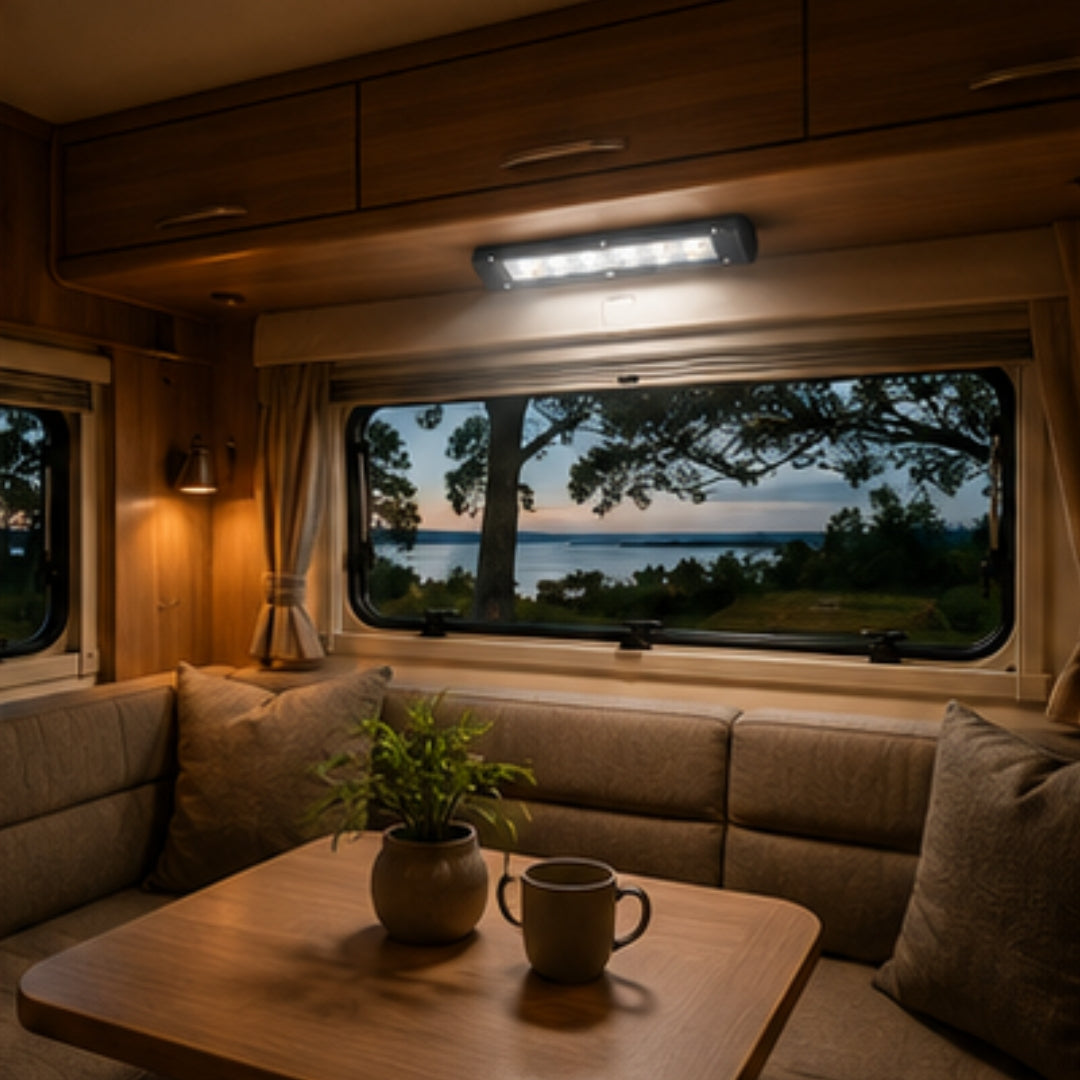 Interior of a camper van with a view of a lake at dusk.