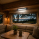 Interior of a camper van with a view of a lake at dusk.