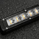 LED light bar on a textured black surface with water droplets