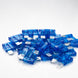 Pile of blue automotive fuses on a white background