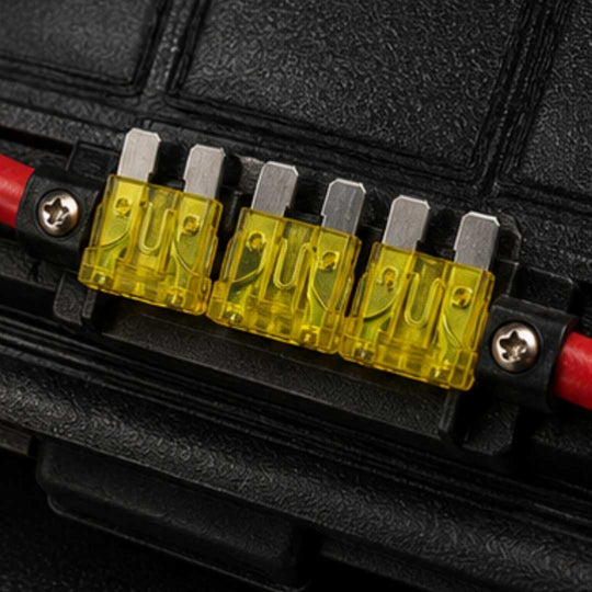 Set of yellow fuses in a black fuse holder