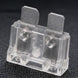 Clear plastic electrical component with metal contacts on a dark background