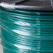 Close-up of a roll of green wire on a black background