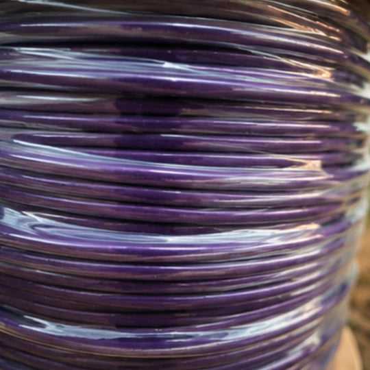 Close-up of a spool of purple cable