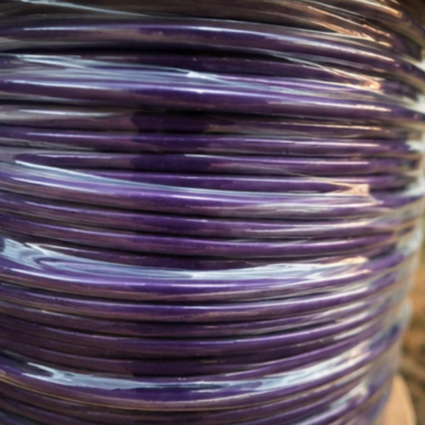 Close-up of a spool of purple cable