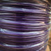 Close-up of a spool of purple cable