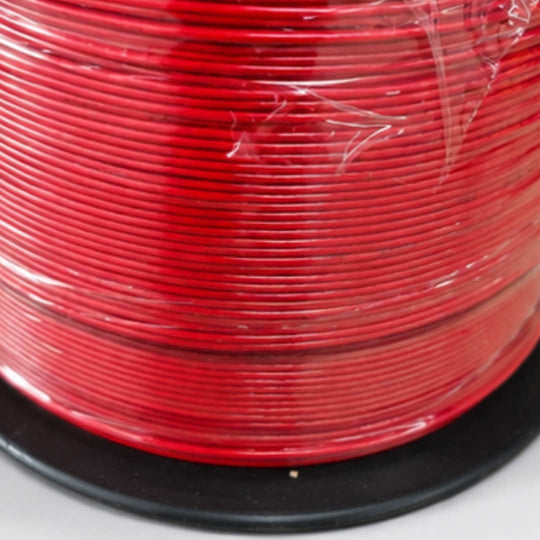 Spool of red wire on a white background