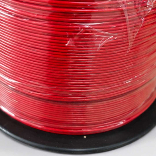 Spool of red wire on a white background