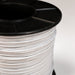 Spool of white cable with black top on a light gray background