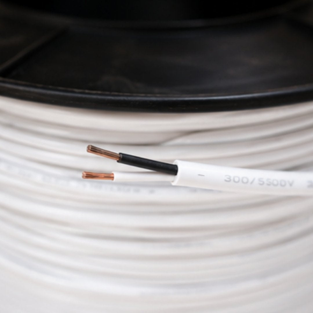 Close-up of a spool of white cable with visible branding.