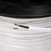 Close-up of a spool of white cable with visible branding.