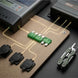 Electronic components on a breadboard with a multimeter and knife in the background