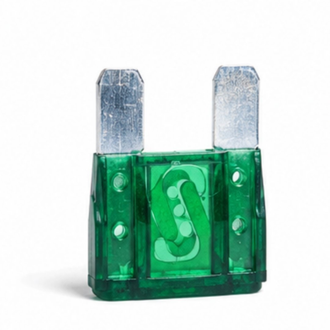 Green plastic fuse with metal blades on a white background