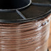 Close-up of a spool of brown wire with a black lid.