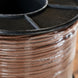 Close-up of a spool of brown wire with a black lid.