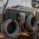 Cord organizer mounted on a vehicle with coiled cables
