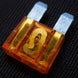 Car fuse with clear cover on a textured black background