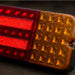 Close-up of a red and orange vehicle light on a dark background