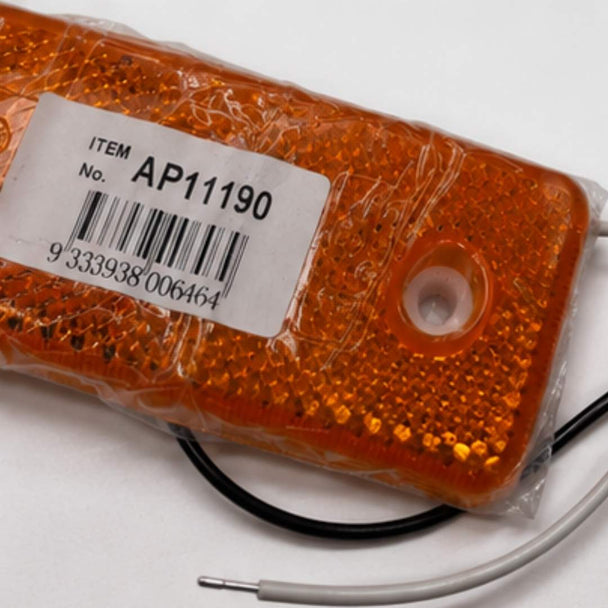 Orange LED light with a barcode label on a white background