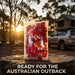 Camping scene with a car and tent in the Australian outback, featuring a red and white patterned blanket.