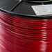 Close-up of a spool of red wire with a label on a black background