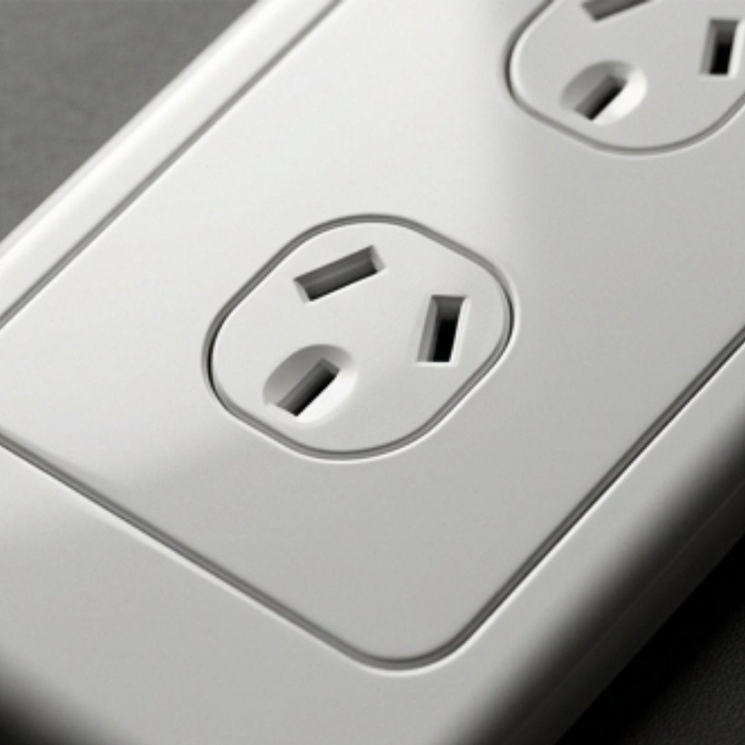 Close-up of a white electrical outlet on a gray background