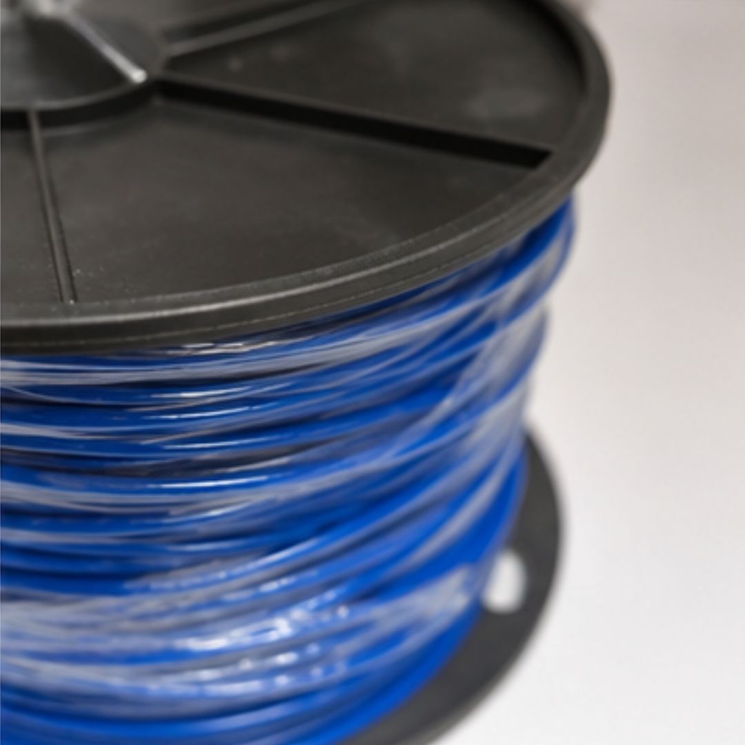 Spool of blue wire on a black reel