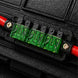 Close-up of a black electrical connector with green and red terminals.