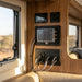 Control panel with multiple displays and connectors inside a vehicle, likely an RV or camper.