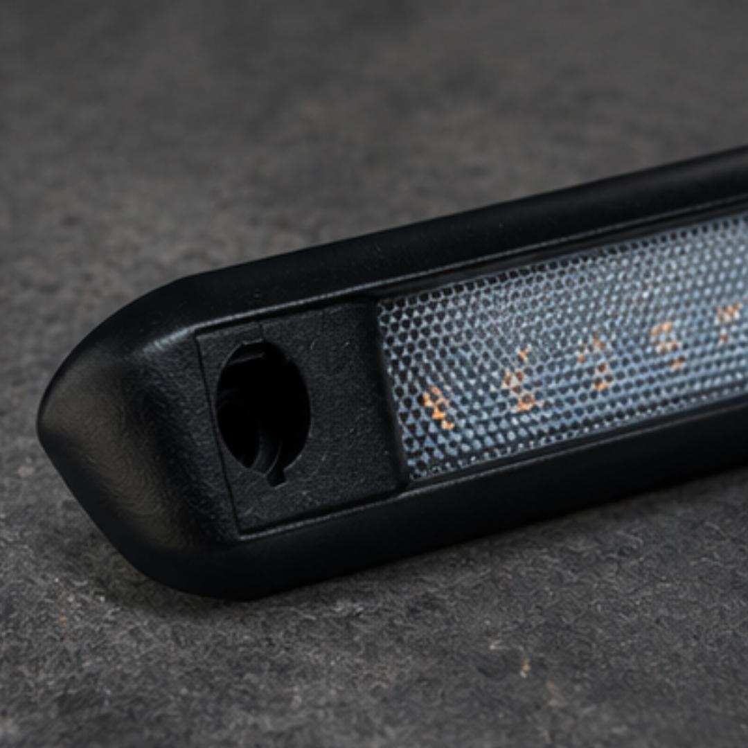 Close-up of a black electronic device with a textured surface on a dark background