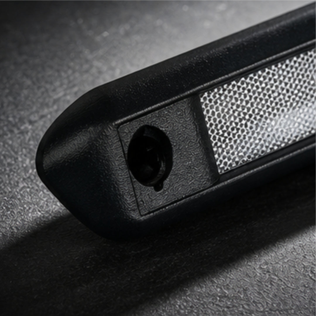 Close-up of a textured black object on a dark surface