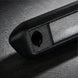 Close-up of a textured black object on a dark surface