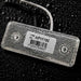 Rectangular electronic component with a label on a dark textured background