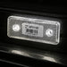 Red LED light on a vehicle with a visible barcode label.