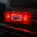 Red LED light on a vehicle with a visible barcode label.