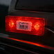 Red LED light on a vehicle with a visible barcode label.