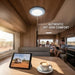 Interior of a modern RV with family inside, featuring a tablet and coffee on a table.