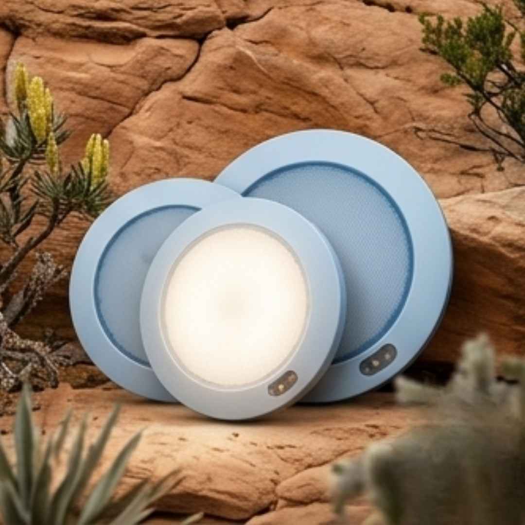Two round blue lights on a rocky surface with front view