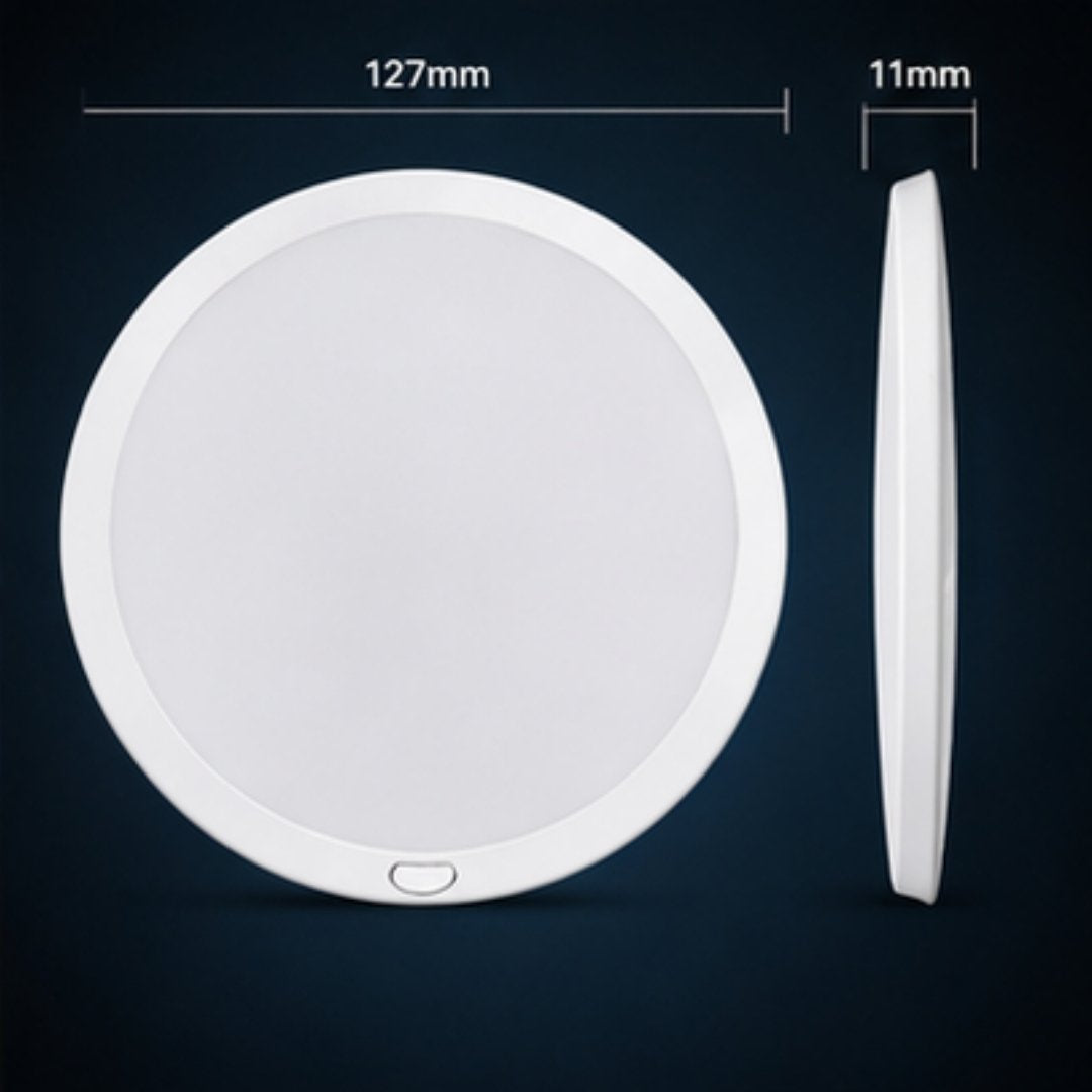 White round wireless charging pad with dimensions on a dark background