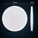 White round wireless charging pad with dimensions on a dark background