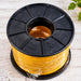 Spool of yellow cable on a black plastic reel with a white background