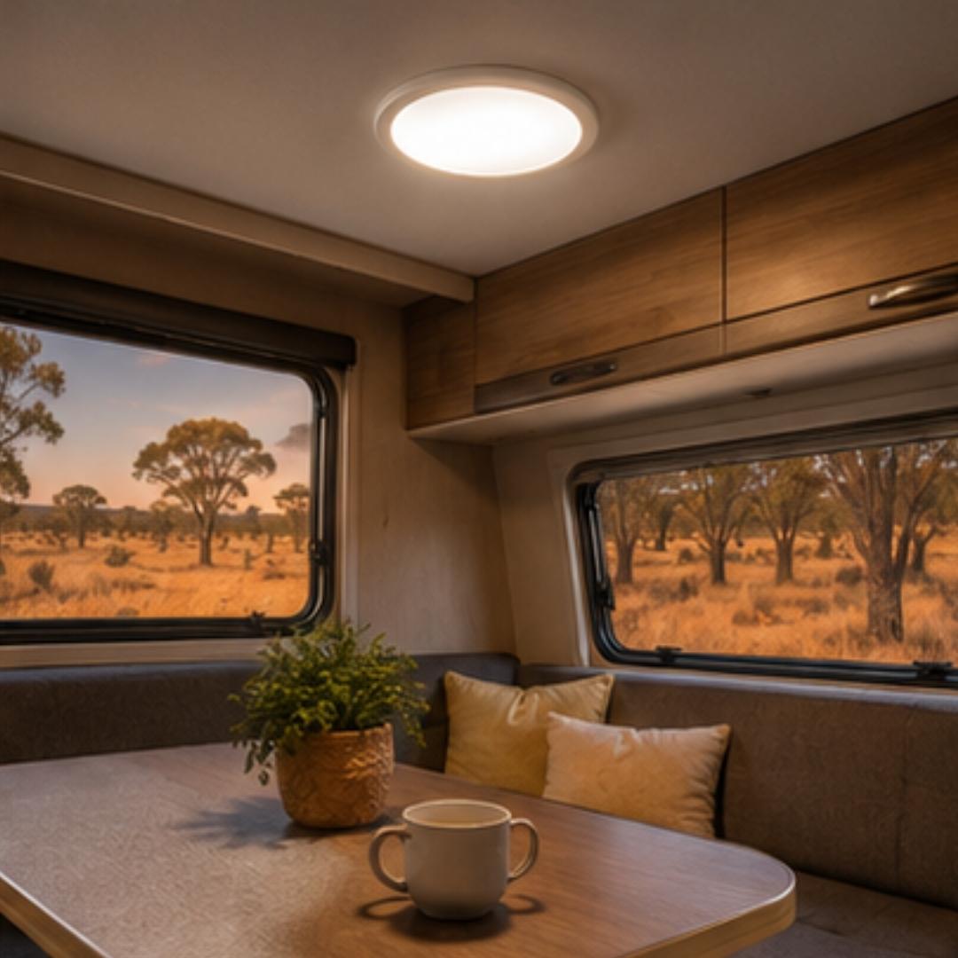 Interior of a camper van with a view of a tree-lined landscape outside the windows.