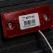Red reflective label with barcode and text on a dark background
