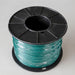 Spool of green wire on a black plastic reel against a light gray background